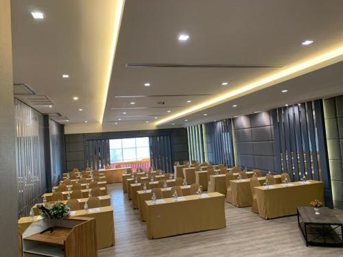 a conference room with tables and chairs in it at Som-O House Hotel in Nakhon Ratchasima