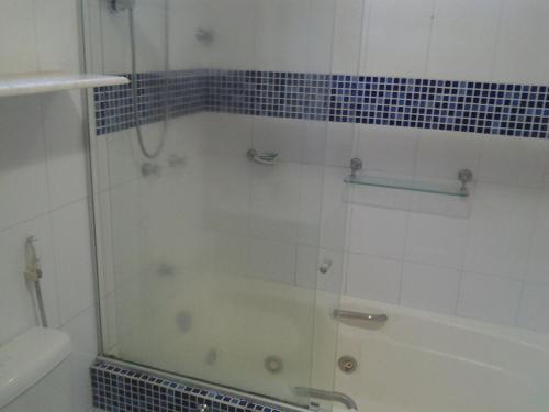 a shower with a glass door in a bathroom at Pousada Ipitanga IV in Lauro de Freitas