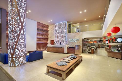 a lobby of a store with a table in the middle at Harper Kuta Hotel by ASTON in Legian