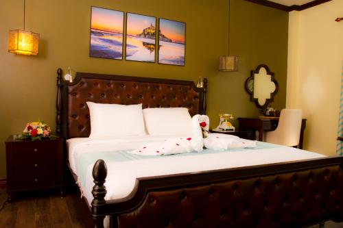 a bedroom with a bed with a teddy bear on it at Sunrise Garden House - Luang Prabang in Luang Prabang