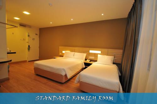Una cama o camas en una habitación de U Design Hotel Temerloh