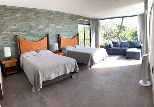 A bed or beds in a room at Casa de las Aves - Alberca y Jacuzzi climatizados - Espectaculares vistas
