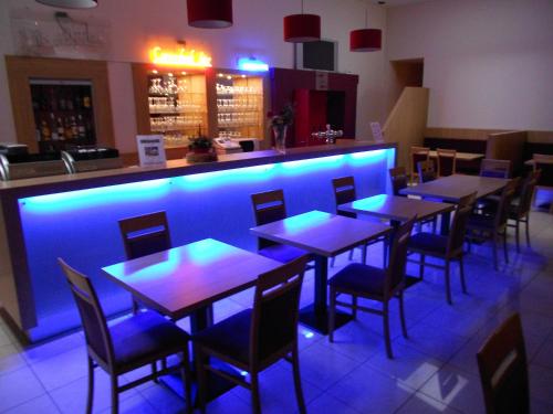 a restaurant with tables and chairs with blue lighting at Hotel Euro Capital Brussels in Brussels