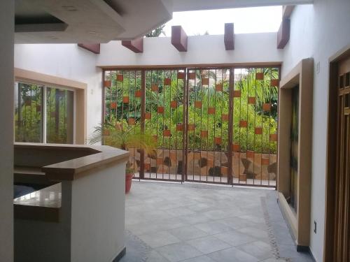 a room with a door with a fence with plants at Palmas de Chahue in Santa Cruz Huatulco