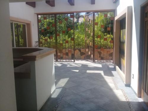 an entrance to a house with a gate with plants at Palmas de Chahue in Santa Cruz Huatulco