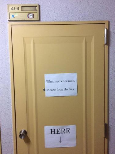 a sign on a door with a sign on it at Casa Viento Stay Inn in Hiroshima
