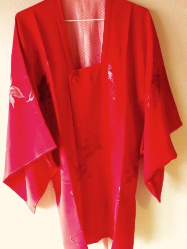 a red shirt is hanging on a wall at Casa Viento Stay Inn in Hiroshima