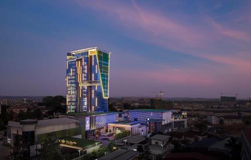 a tall building with lights on it in a city at Prince Times Hotel in Sihanoukville