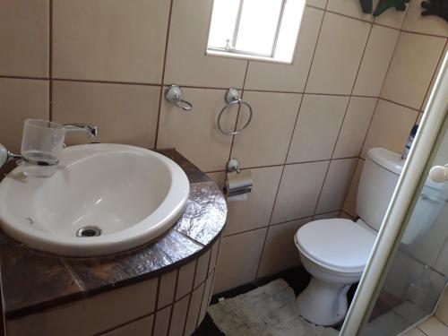 a bathroom with a sink and a toilet at Bellamia in Marloth Park