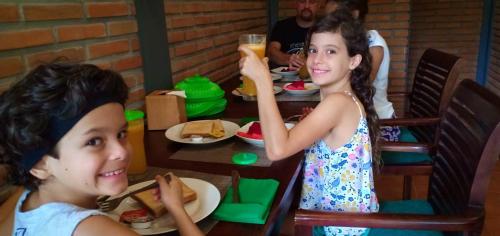 two young girls sitting at a table eating food at Ubud Taksu Homestay in Ubud