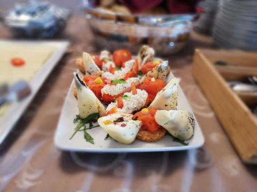 a plate of food with vegetables on a table at Monterai Resort in Poiana Brasov