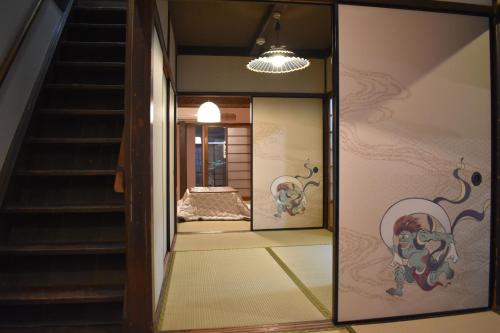 a mirror in front of a room with a bed at Nishioji TANUKI in Kyoto