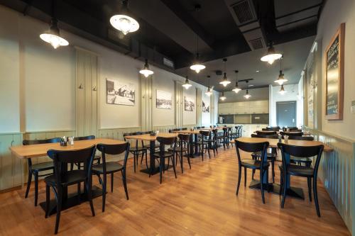 a row of tables and chairs in a restaurant at Apartmány U Gigantu in Pilsen