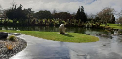 a park with a statue in the middle of a pond at Rose Apartments Unit 6 Central Rotorua-Accommodation & Spa in Rotorua