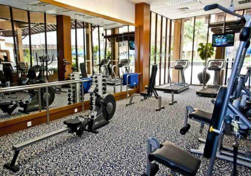 a gym with several treadmills and exercise bikes at Royale Chulan Kuala Lumpur in Kuala Lumpur
