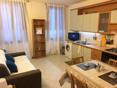 a kitchen and a living room with a couch and a table at Romantic Venice in Venice