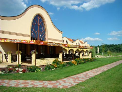 a building with a lawn in front of it at Wellness hotel Spark in Malacky