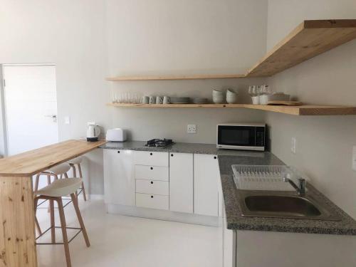 a kitchen with a sink and a counter top at Still Bay East Beach Apartment in Stilbaai