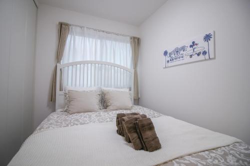 a bedroom with a bed with a bag on it at CASA Higashi Mikuni 02 in Osaka