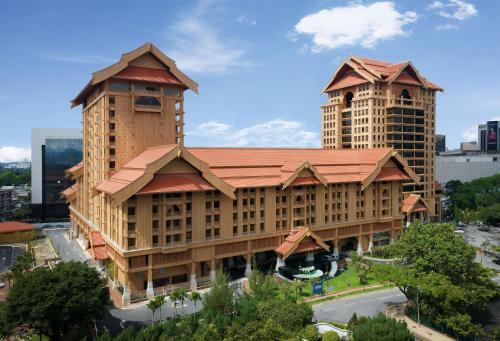 a large building with a red roof and two tall buildings at Royale Chulan Kuala Lumpur in Kuala Lumpur