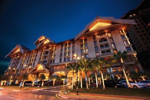 a large building with palm trees in front of a street at Royale Chulan Kuala Lumpur in Kuala Lumpur