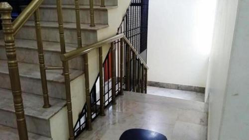 a stairway with a metal railing and a stair case at Rehaish Inn Furnished Rental Accommodation in Karachi