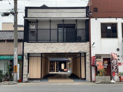 a building with a balcony on the front of it at Imagine Annex in Kyoto
