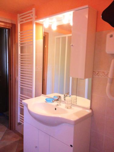 a bathroom with a white sink and a mirror at Ulivi sul Garda Garden by Gardadomusmea in Tremosine Sul Garda