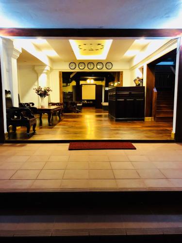 a large room with a lobby with a table and chairs at Merry Riverside Hotel in Luang Prabang