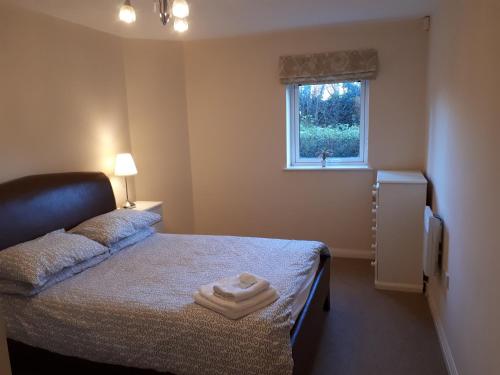 a small bedroom with a bed and a window at The Avenue in Leamington Spa
