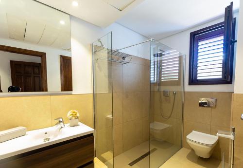 a bathroom with a shower and a toilet and a sink at Can Bernadet in San Jose