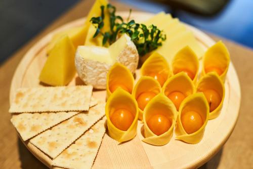 a plate of eggs and cheese and crackers on a table at CitiGO Hotel Hongqiao Shanghai in Shanghai