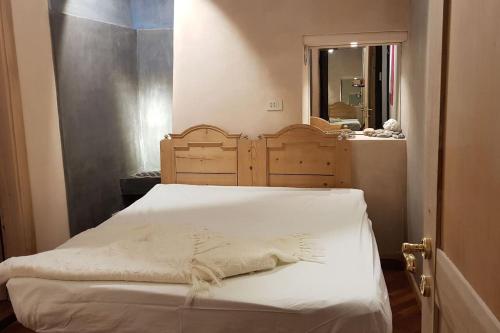 una camera con letto con testiera in legno e finestra di Ugo Architect's Lodge Classic a Bolzano