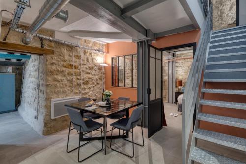 une salle à manger avec une table et des chaises et un escalier dans l'établissement Gravilliers, à Paris