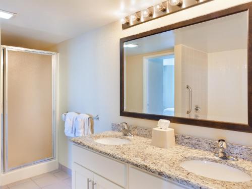 a bathroom with two sinks and a large mirror at Boardwalk Resorts at Atlantic Palace in Atlantic City