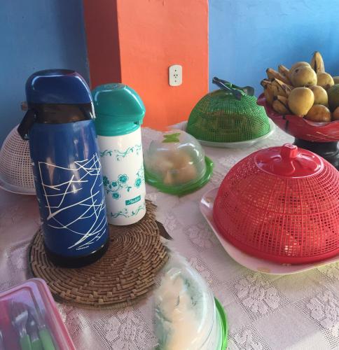 een tafel vol met kopjes en borden in verschillende kleuren bij POUSADA MARINA PRAiA in Beberibe