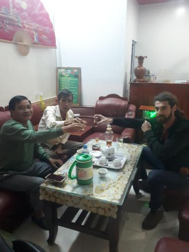 a group of men sitting around a coffee table at Hotel Thanh Minh in Châu Làng Chánh