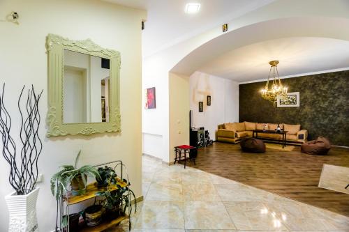 a living room with a mirror and a couch at Comfortable House on Marjanishvili in Tbilisi City