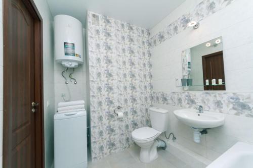 La salle de bains est pourvue de toilettes et d'un lavabo. dans l'établissement Уютные апартаменты на Улице Русова 7 метро 15 минут, à Kiev