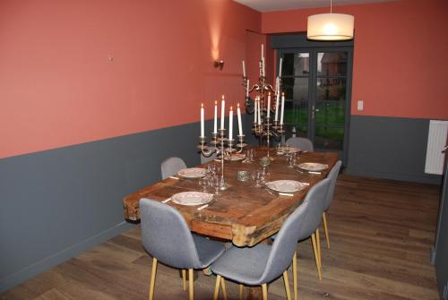 a dining room with a wooden table and chairs at La Bergerie - Gîte et Chambres d'Hôtes in Roz-sur-Couesnon