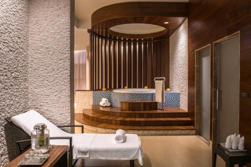 a spa room with a tub and a table at Swissôtel Living Al Ghurair Dubai - Deira - Apartments in Dubai