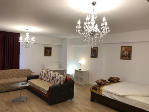 a living room with a couch and a chandelier at Upground Apartments in Bucharest