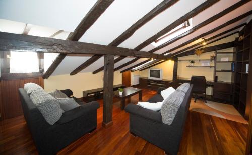 a living room with two chairs and a table at Saioa`s red house in Lekeitio