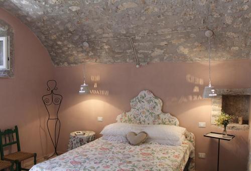 a bedroom with a bed with a heart pillow on it at B&B dell'Osteria in SantʼAnatolia di Narco