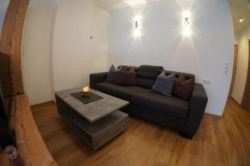a living room with a couch and a table at Appartements Klotz in Ehrwald
