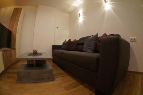 a living room with a couch and a table at Appartements Klotz in Ehrwald