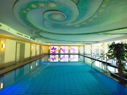 a swimming pool with a large ceiling and a swimming pool at Das Pfandler in Pertisau