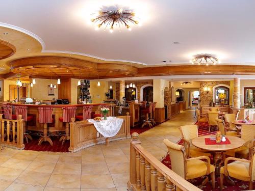 a restaurant with tables and chairs and a bar at Das Pfandler in Pertisau