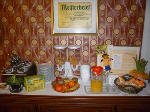 a buffet with food and drinks on a table at Pension Villa Else in Heidenau
