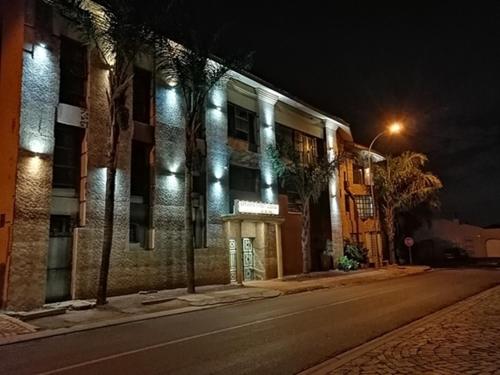 a building with lights on the side of a street at Lenasia Guest Lodge in Lenasia